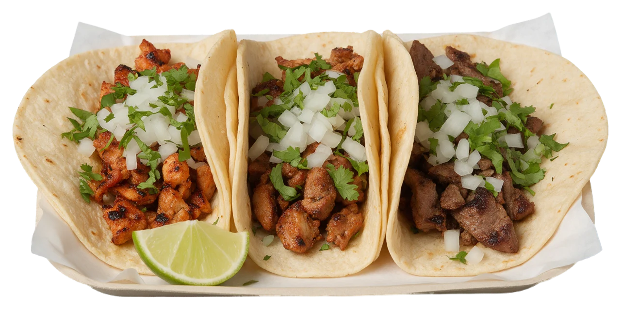Three soft corn tortilla street tacos with grilled meat, onion, cilantro and a lime wedge on a paper lined tray