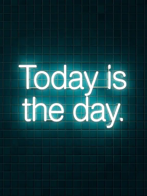 Glowing white neon sign reading "Today is the day." mounted on a dark teal tiled wall