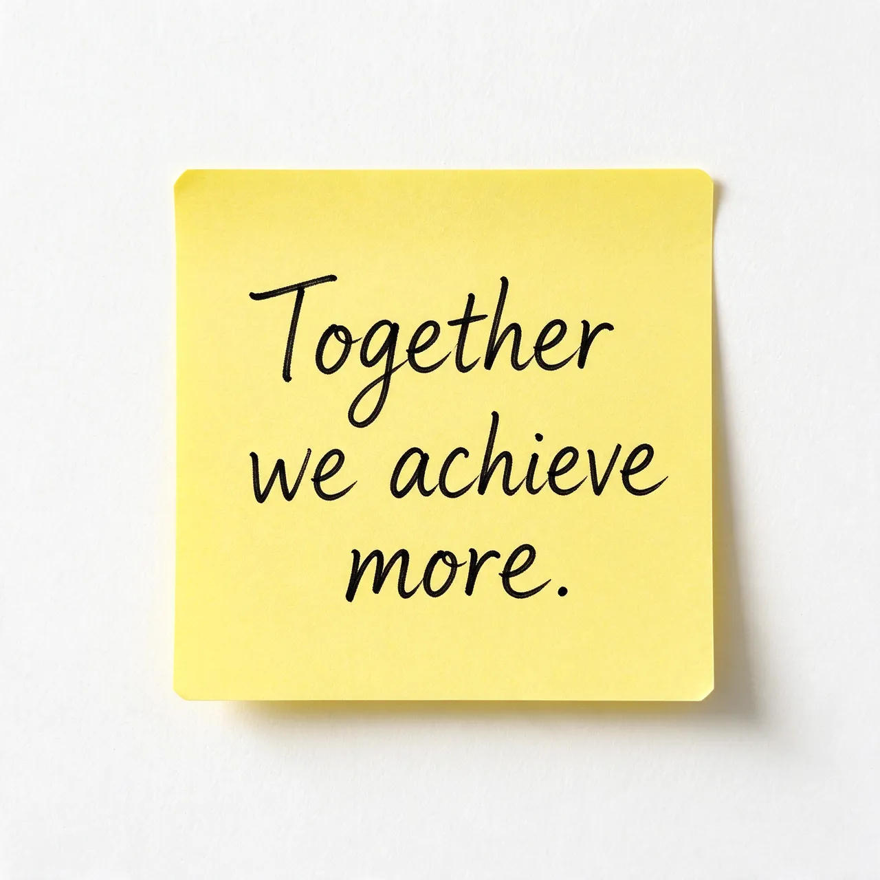 Handwritten black text reading "Together we achieve more." on a yellow sticky note against a white wall