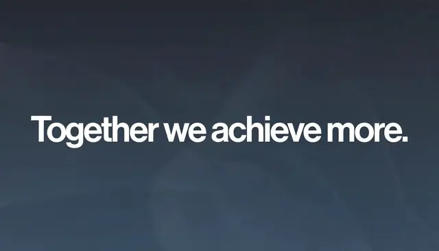 Bold white sans-serif text reading "Together we achieve more." centered on a dark slate blue gradient desktop wallpaper