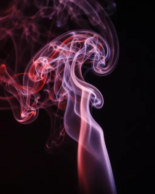 Glowing twisting red and purple smoke wisps curl against a solid black background