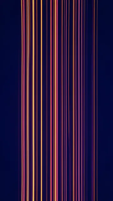 Glowing vertical orange and pink light threads rise against a deep indigo background