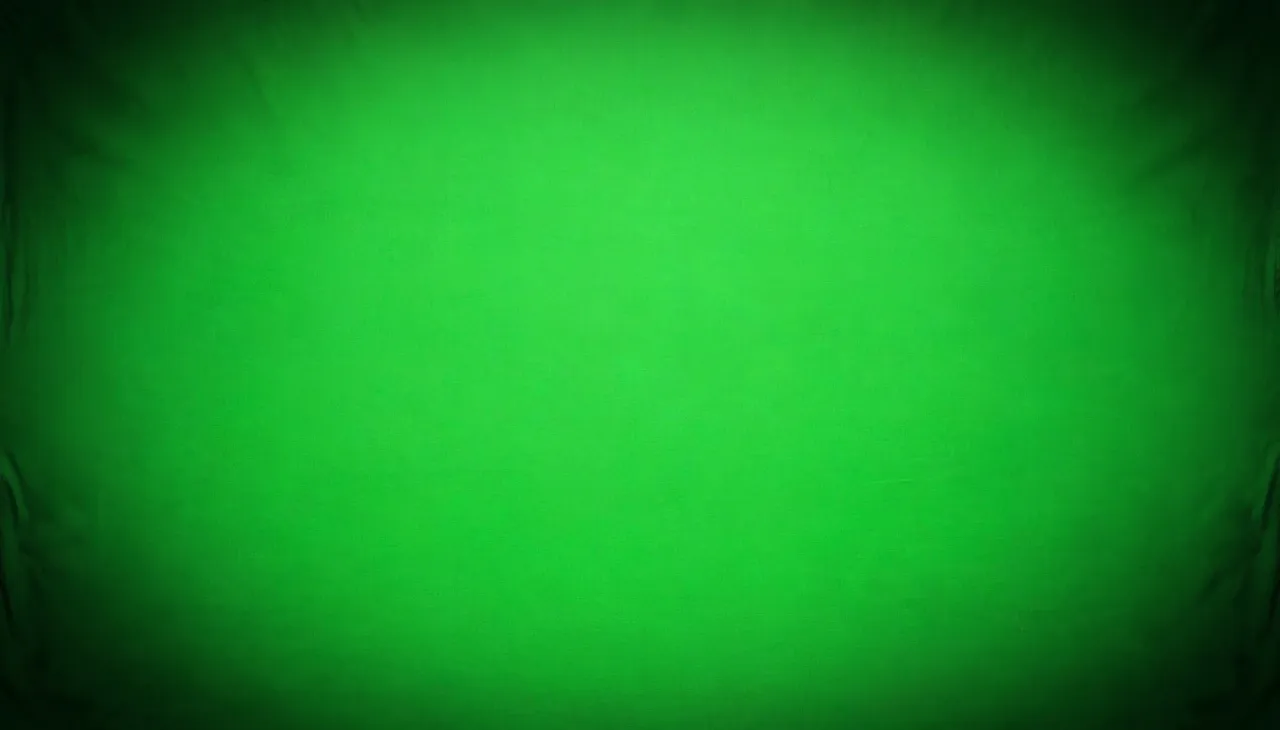 Chromakey green fabric background with a soft dark vignette at all corners and evenly lit center