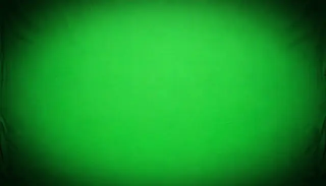 Chromakey green fabric background with a soft dark vignette at all corners and evenly lit center