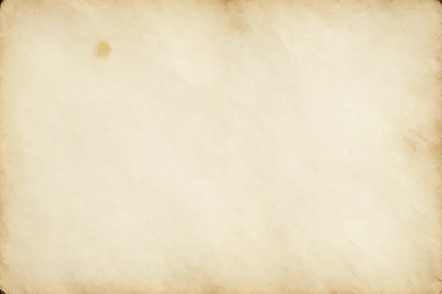 A close-up of faded, stained old paper with subtle crinkles and warm browned edges