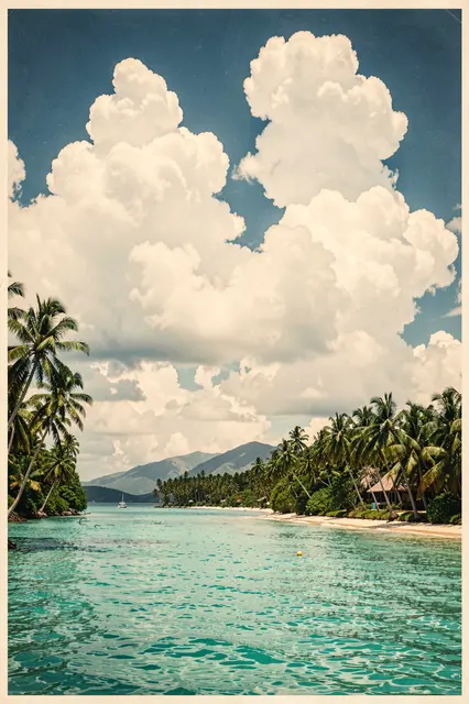 Turquoise tropical bay framed by palm trees under towering fluffy cumulus clouds