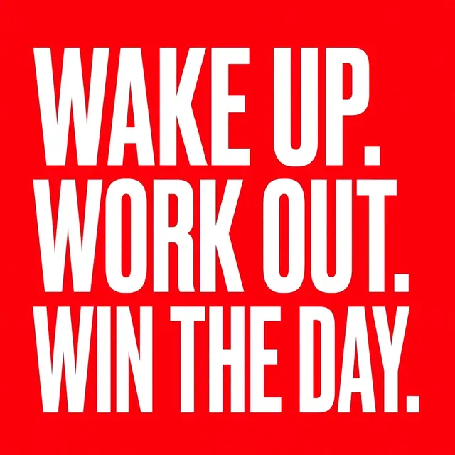 Bold white condensed stacked capitals displaying "Wake up. Work out. Win the day." on a solid bright red background