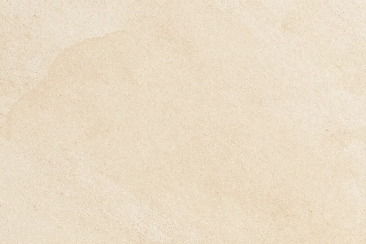 Smooth natural warm beige travertine stone surface with subtle tonal variations across the frame