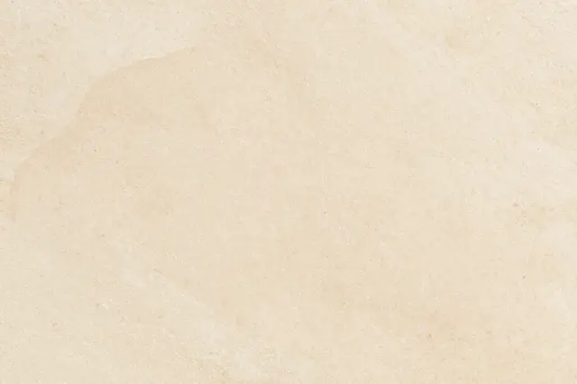 Smooth natural warm beige travertine stone surface with subtle tonal variations across the frame