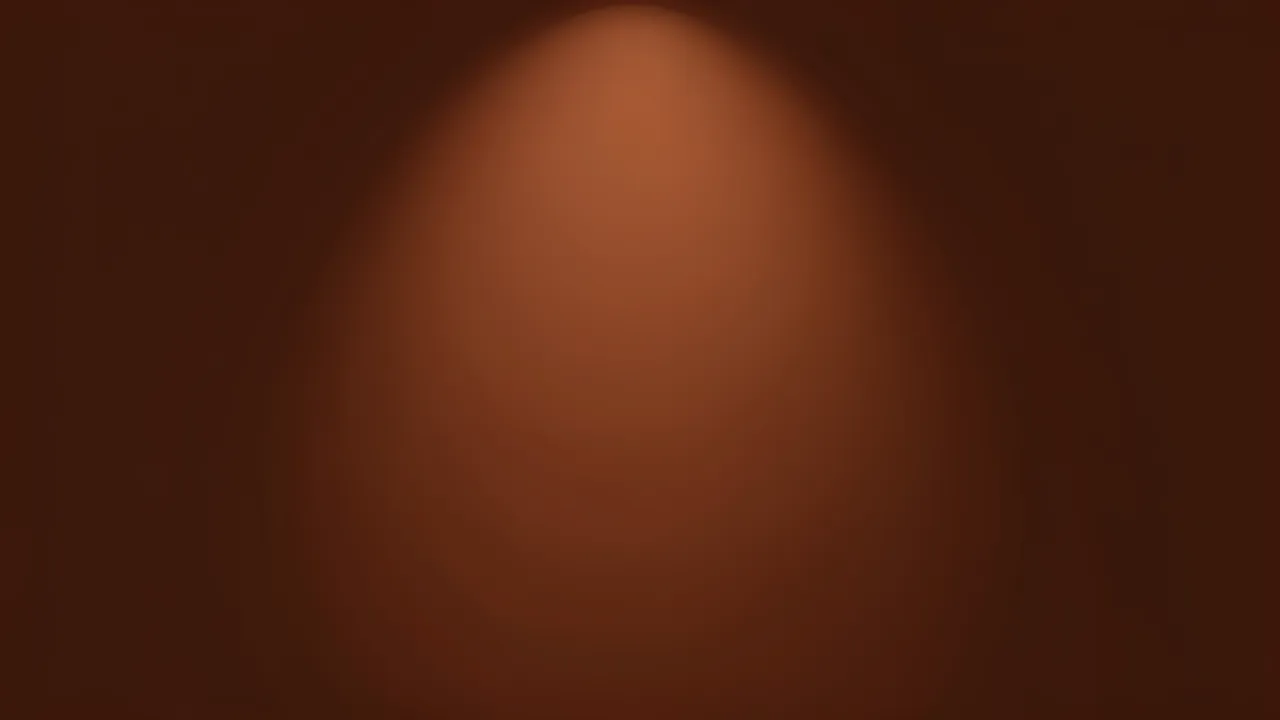 A smooth chocolate brown background with a soft warm spotlight glowing in the center