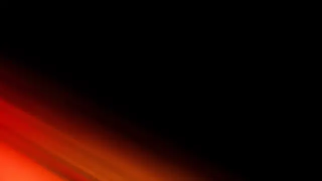Soft red and amber diagonal light streaks extend from the bottom left against solid black