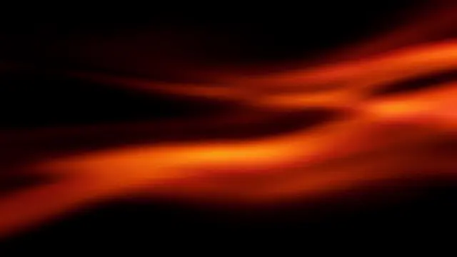 Soft streaking orange and red film light leaks drift across a solid black background