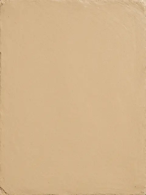Full frame close-up of fine straw-infused clay plaster in soft warm sand tones