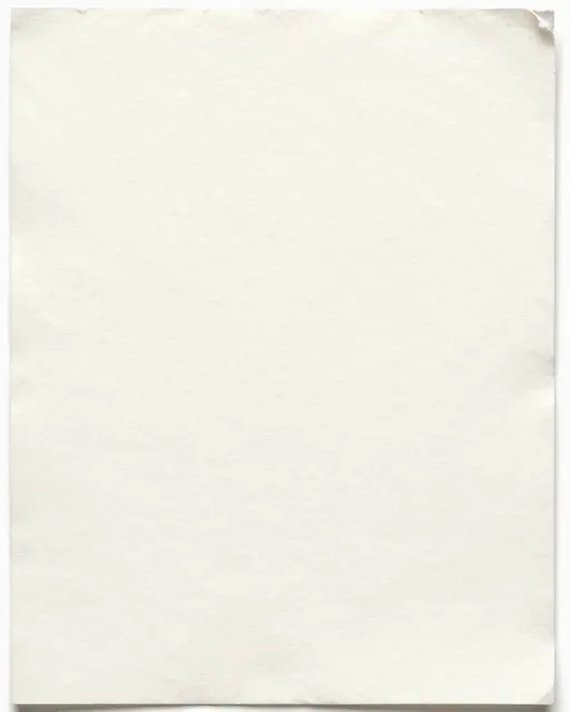 Full frame close-up of warm white cotton rag paper with soft deckled edges and loose natural fibers