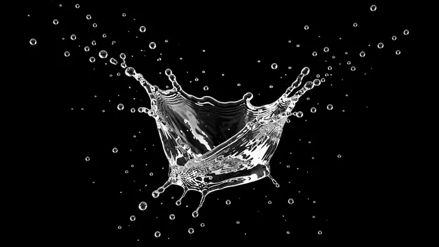 Transparent water splash with outward flying droplets against a solid pure black background
