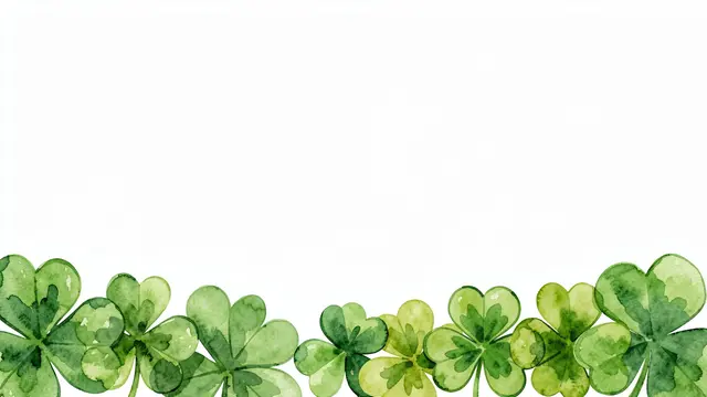 Hand-painted watercolor shamrocks line the bottom edge of a blank white background