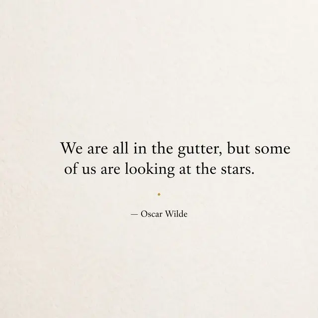 Minimalist quote card with off-white textured background, black serif text, small gold dot divider, reading "We are all in