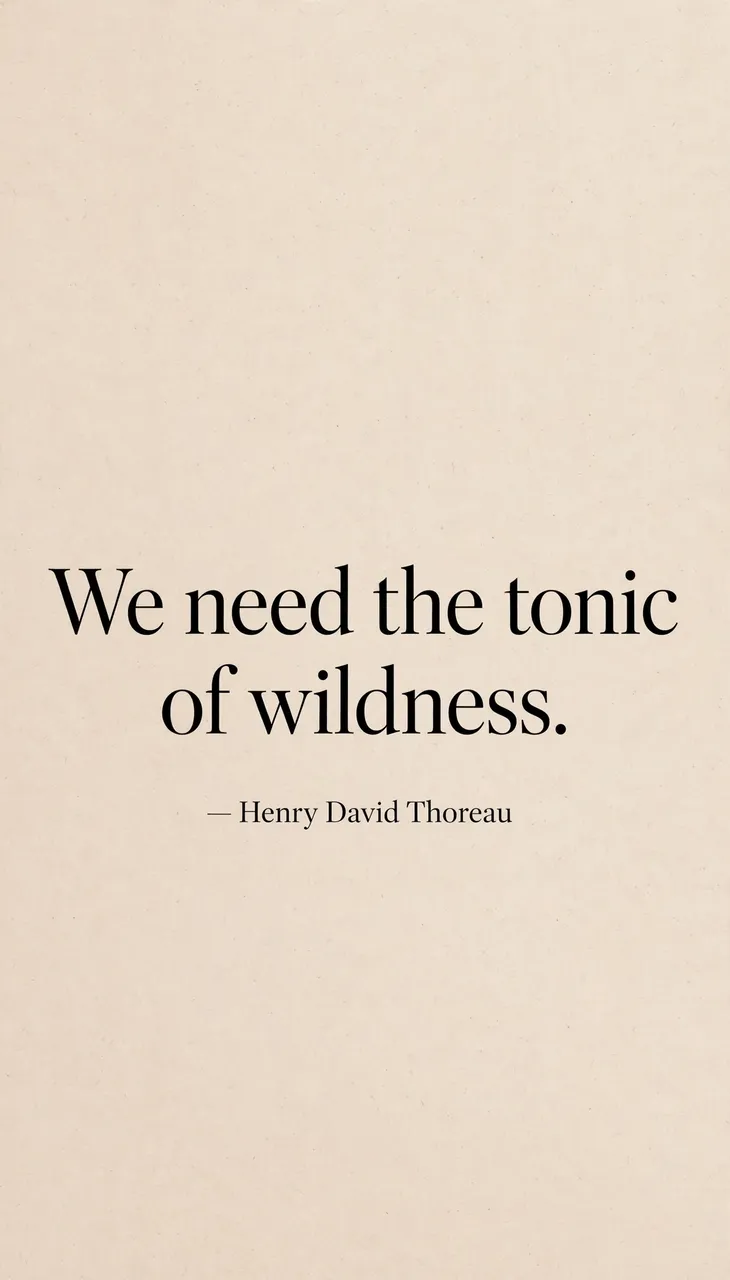 Vertical warm sand beige minimalist wallpaper displaying the quote "We need the tonic of wildness. — Henry David Thoreau" in