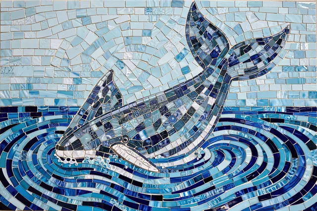 Glass tile mosaic of a whale with raised tail emerging from swirling blue water