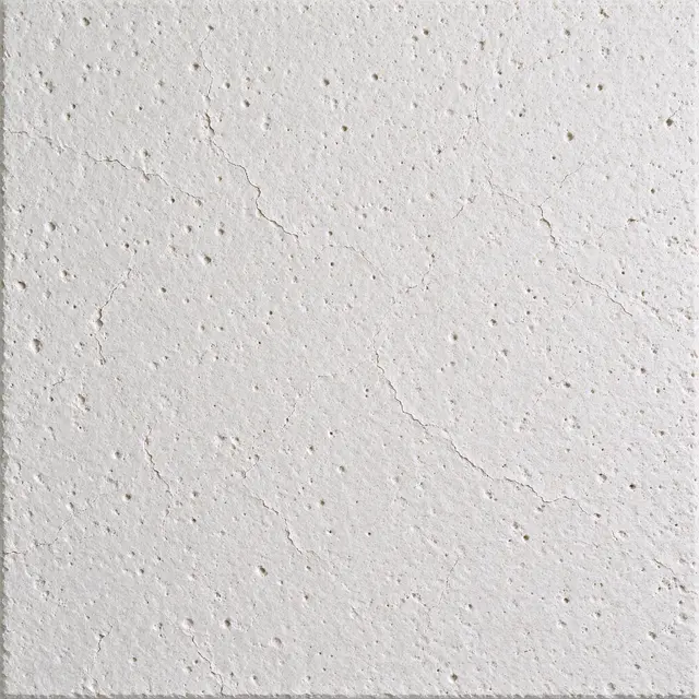 Full frame close-up of a white mineral fiber acoustic panel with fine fissures and small pinholes under even lighting