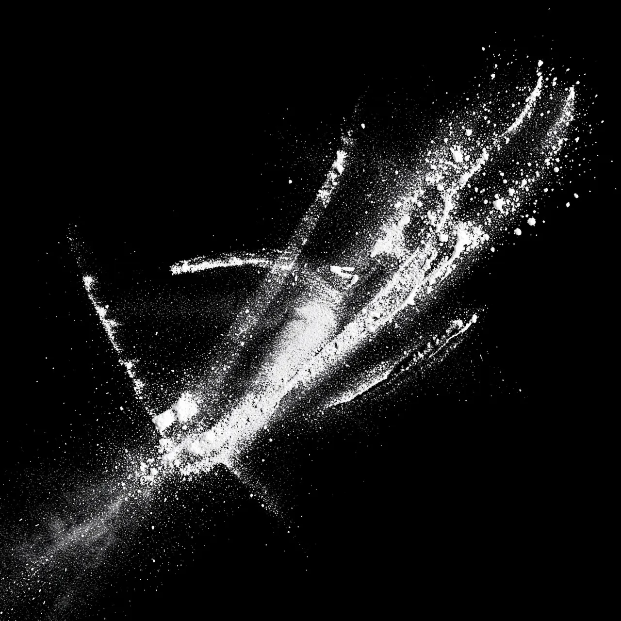 Chalky white dust streaks and scattered particles spread across a solid pure black background