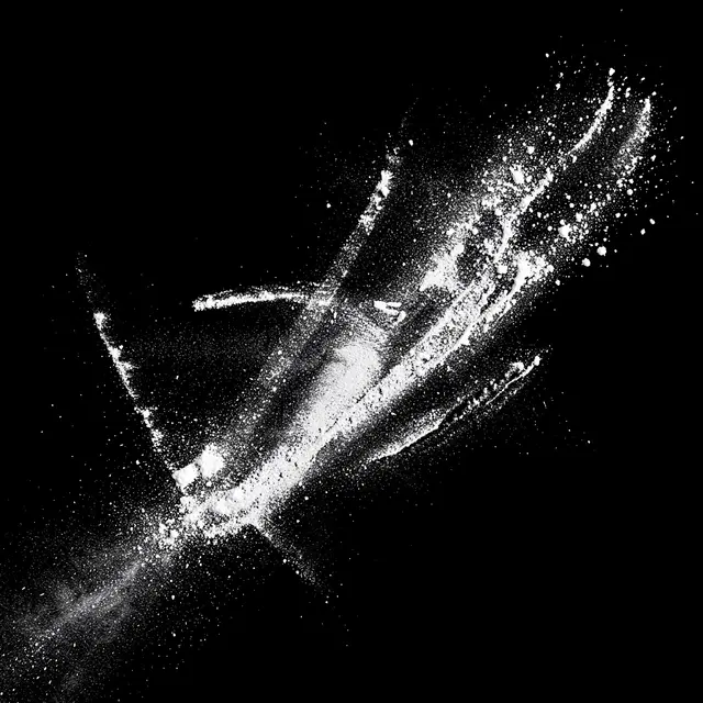 Chalky white dust streaks and scattered particles spread across a solid pure black background