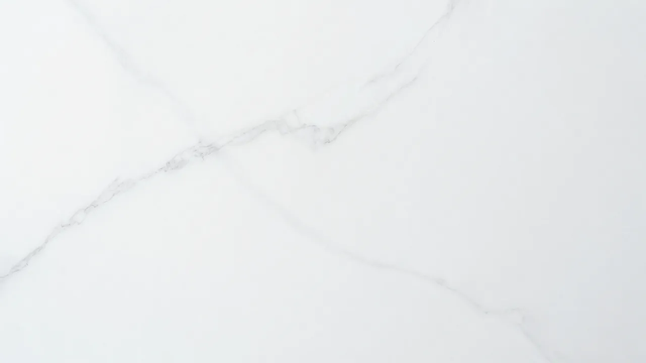Full frame view of smooth white marble with soft flowing gray veins