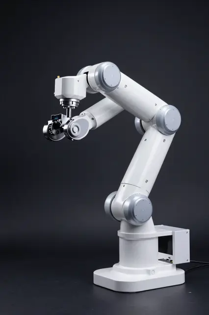 A white articulated robotic arm rests under dramatic side lighting in a dark black studio