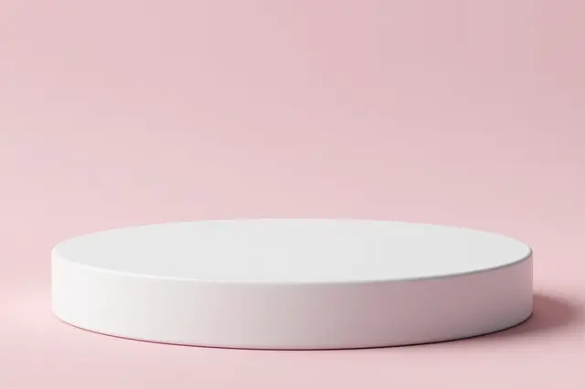 A smooth round white product podium sits against a solid pastel pink background.