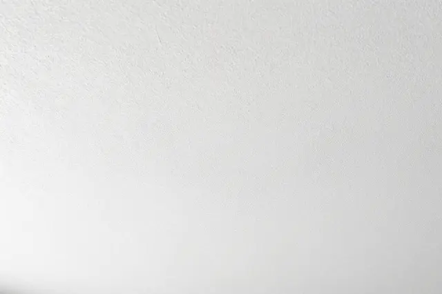Full frame close-up of a subtle textured white knockdown stucco ceiling surface