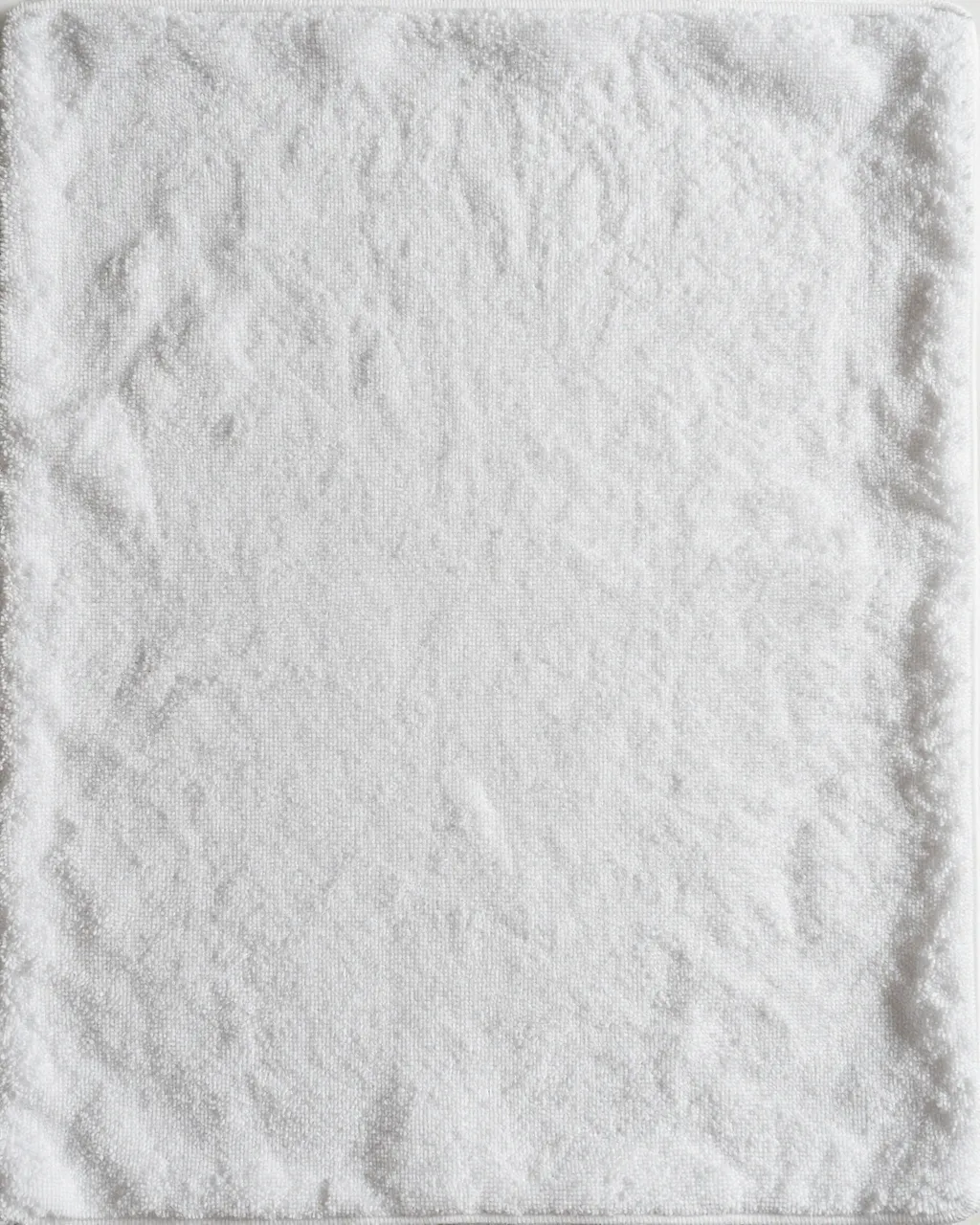 Full frame close-up of soft dense white terry cloth fabric with subtle loop texture