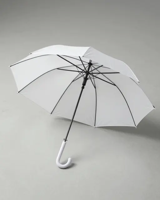 An open plain white umbrella rests on a smooth light gray studio floor