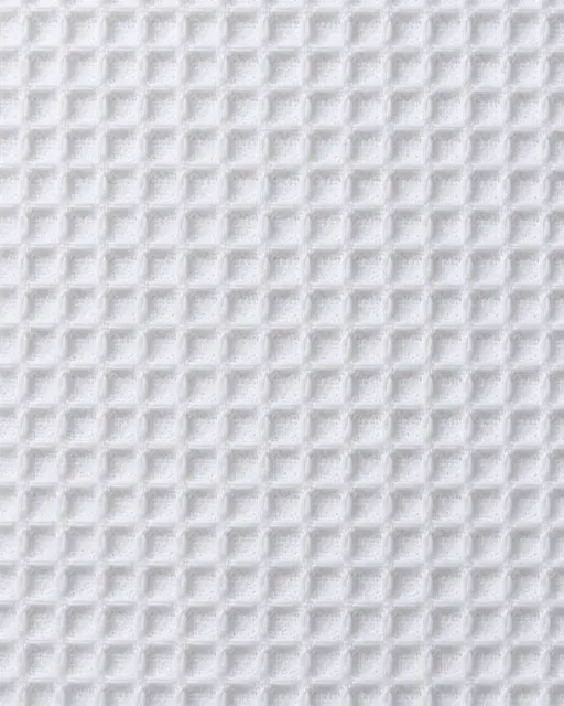 Full frame close-up of uniform white waffle weave cotton fabric with raised square ridges