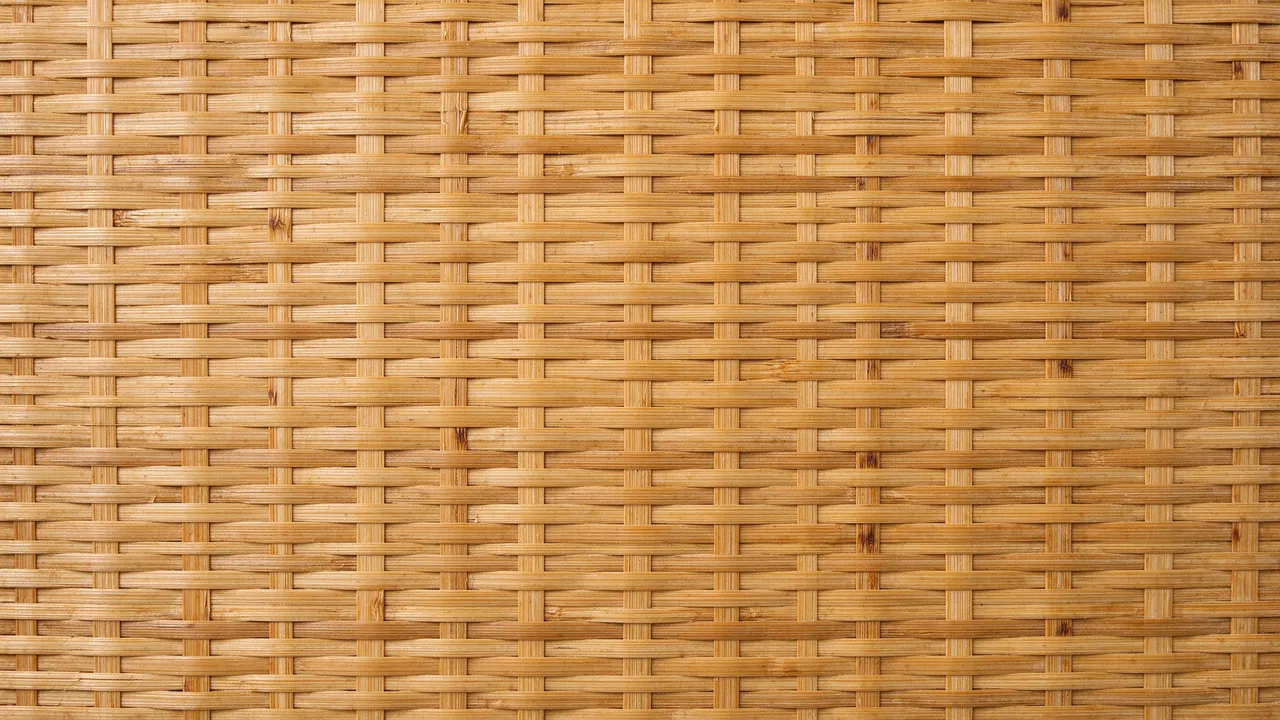 Top view close-up of a tight over-under interlaced woven bamboo mat filling the full frame