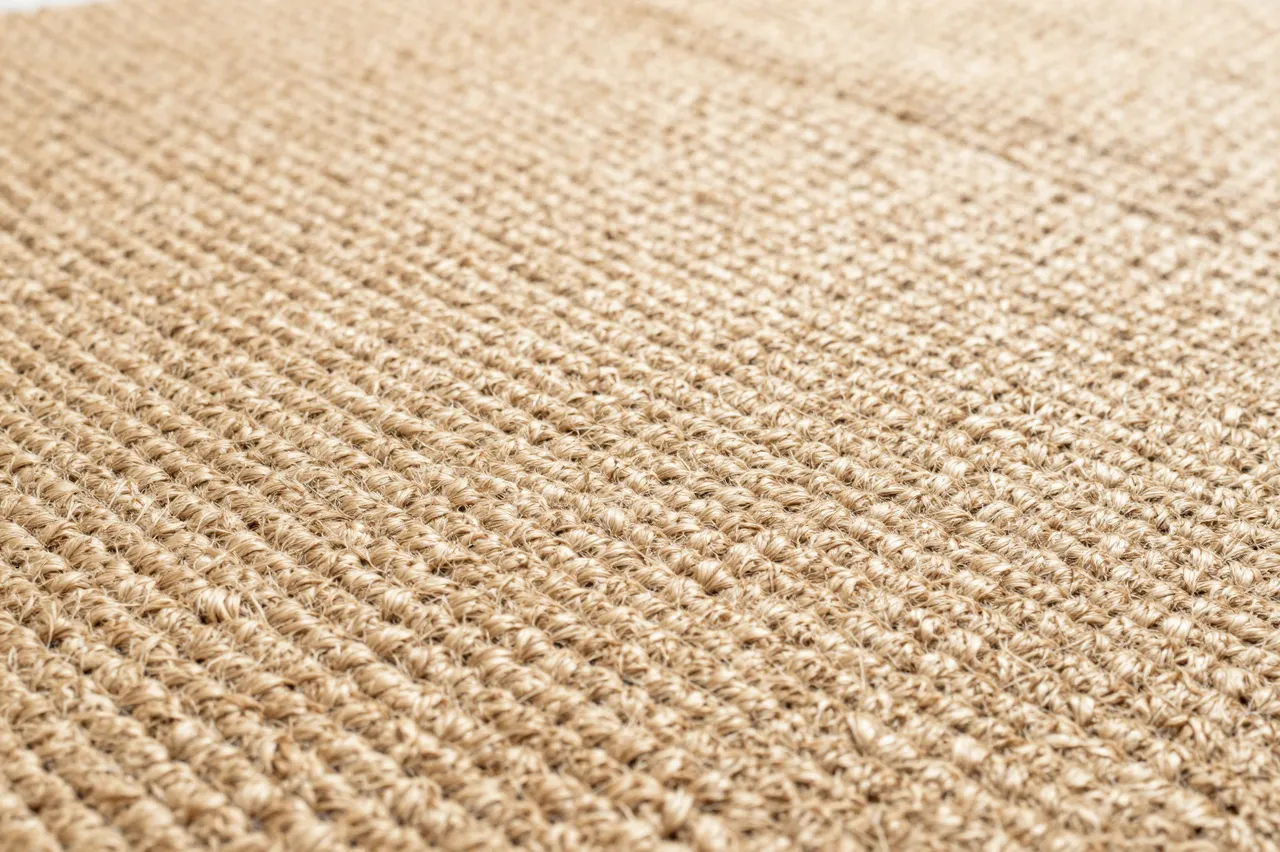 Close-up view of the textured woven surface of a natural jute rug