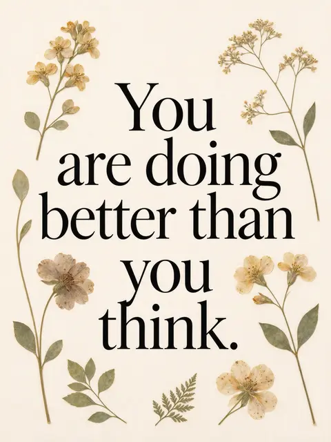 Black serif quote "You are doing better than you think." framed by delicate pressed flowers on a cream background