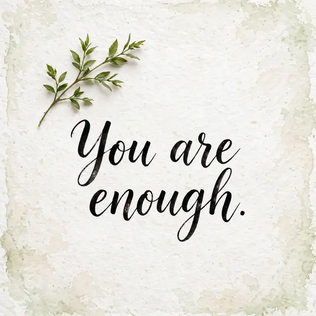"You are enough." in black brush lettering with a green leaf sprig on textured off-white watercolor paper.