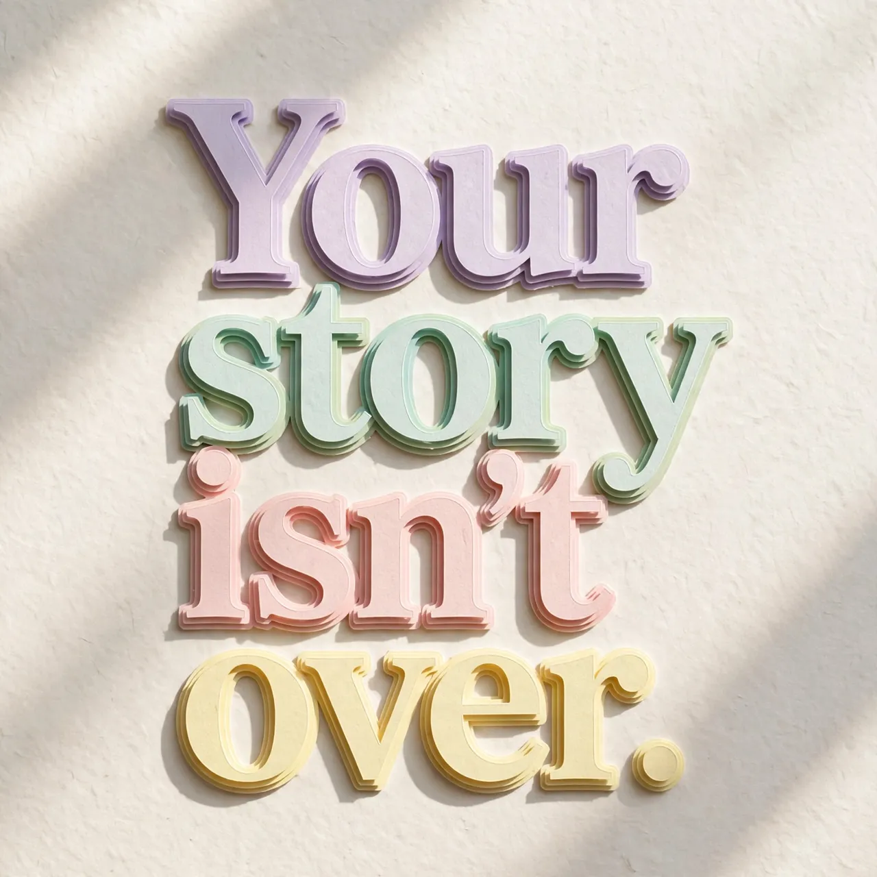 Layered pastel paper cut-out lettering spelling "Your story isn't over." casts soft shadows on a pale textured background.