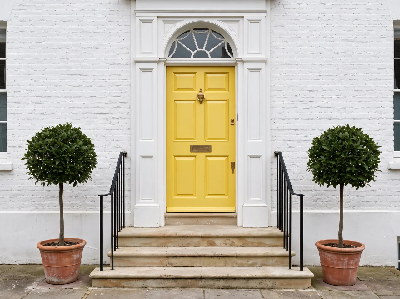 The same entrance with the door painted sunflower yellow; nothing else has changed