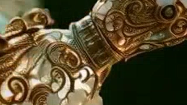 Close-up of a jeweled filigree hummingbird from a 768p AI video, stretched and soft
