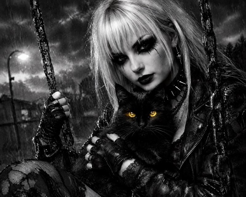 Gothic blonde woman on a chain swing holds a black cat with glowing yellow eyes in a rainy night scene