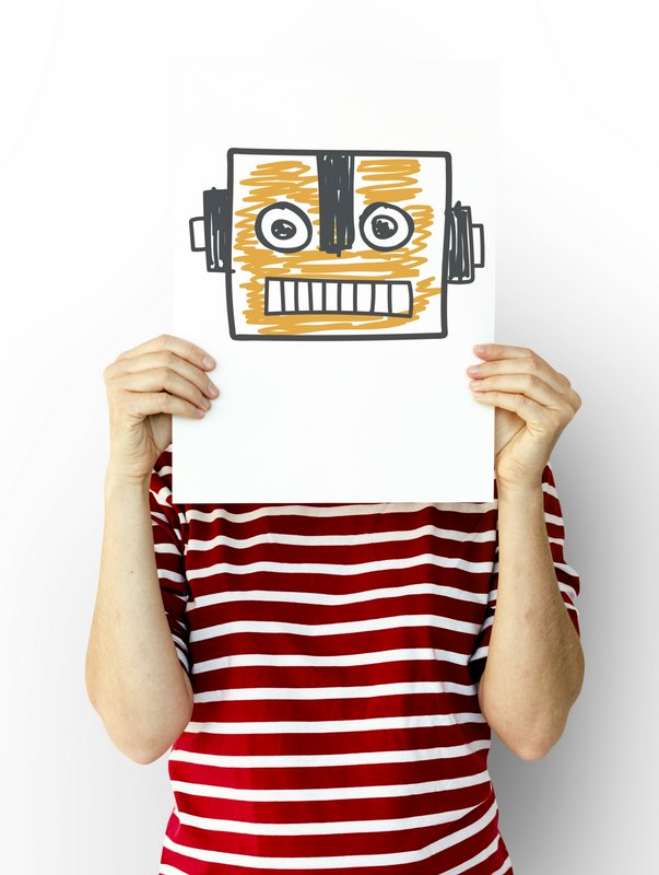 Person holding a hand-drawn robot face drawing in front of their head, wearing a red striped shir...