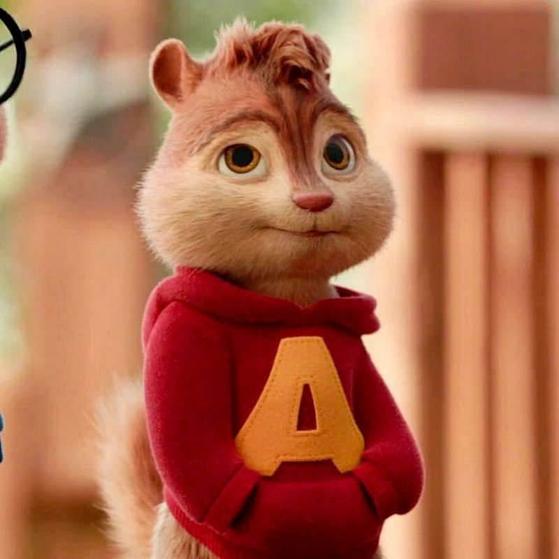 Close-up of animated Alvin from Alvin and the Chipmunks in his signature red hoodie with a yellow...