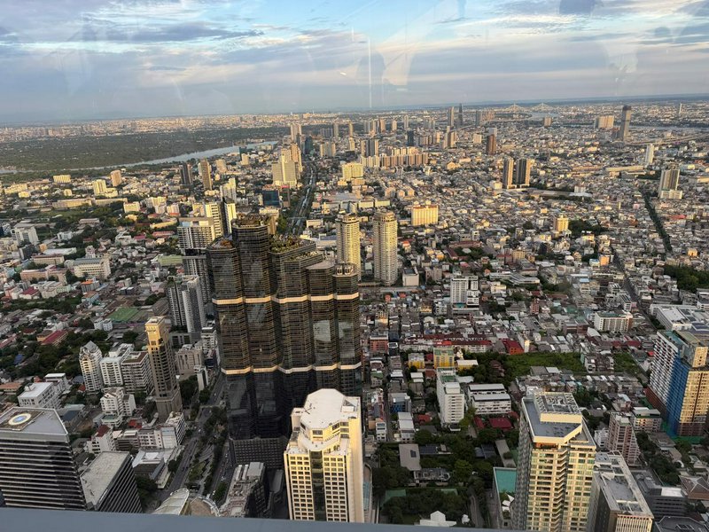 High-angle aerial view of the sprawling Bangkok, Thailand city skyline, shot from a tall observat...