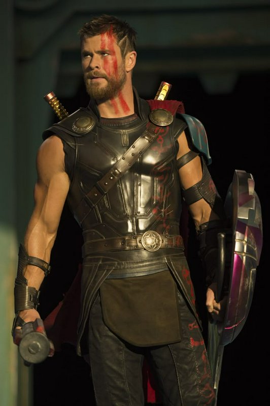 Chris Hemsworth as gladiator Thor from Thor Ragnarok, with red war paint, battle armor, shield, a...