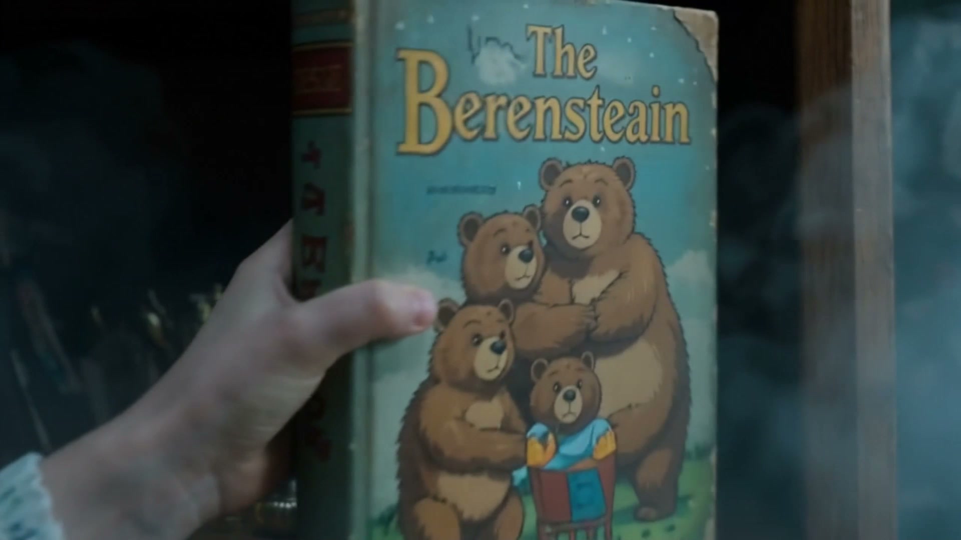 Hand holding a worn vintage The Berensteain children's book with a bear family illustrated front ...
