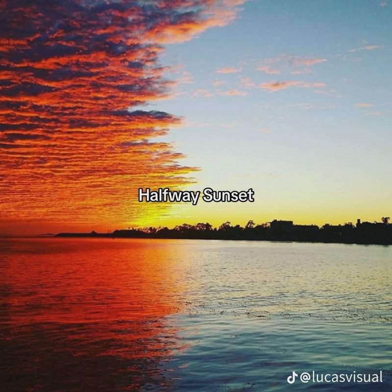 Striking split sunset over calm water, left sky has fiery orange clouds, right is pale blue, "Halfway Sunset" text overlay