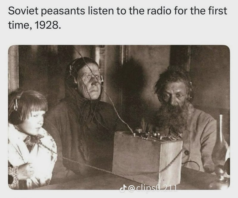 Sepia 1928 historic photo of Soviet peasants wearing wired headphones, listening to an early home...