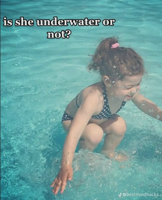 Optical illusion image of a girl crouching in turquoise pool water, overlaid text asks "is she un...