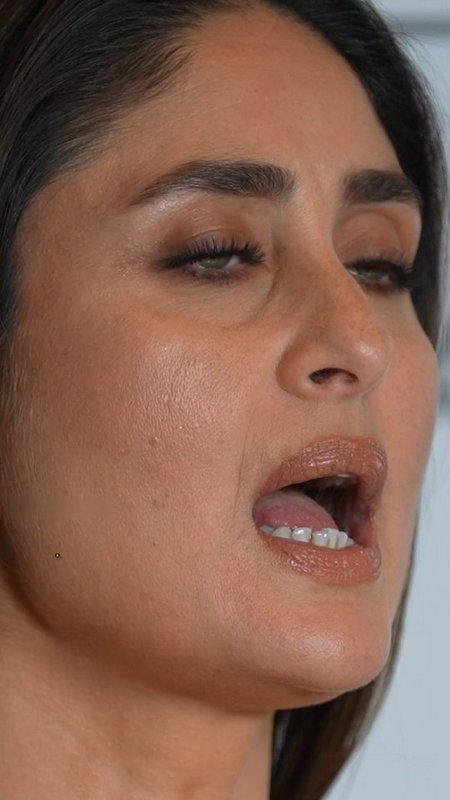 Close-up candid portrait of Bollywood actress Kareena Kapoor Khan with half-lidded eyes, mouth sl...